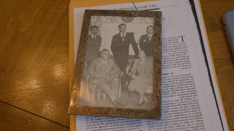 A photo of Dr. Edward Cooper (top right) with his family sits atop a copy of the address he gave in 1992 at Scientific Sessions as president of the American Heart Association. (Courtesy of Dr. Edward Cooper via Mirar Media Group for the American Heart Association)